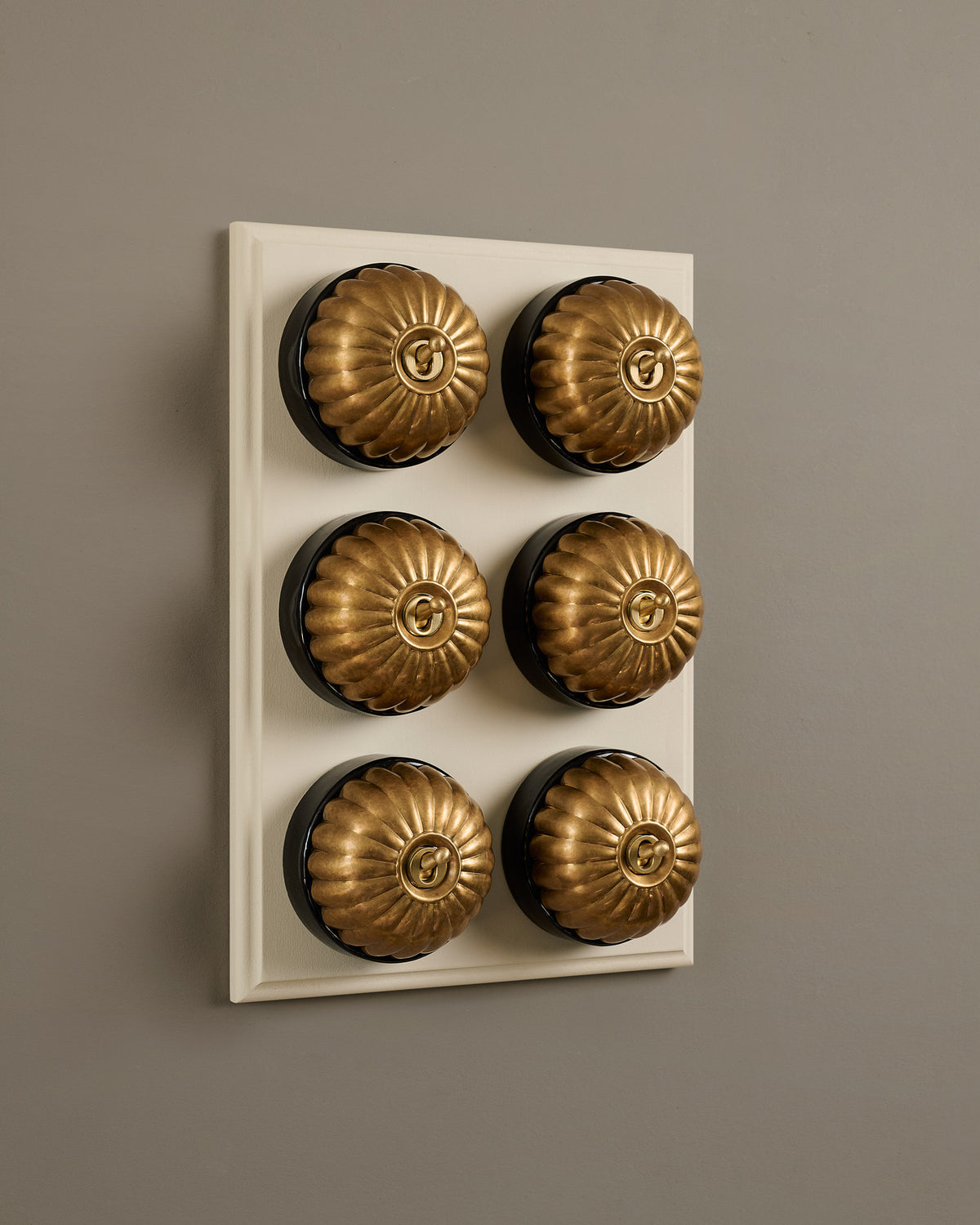 The Jelly Toggle Switch (6 Gang & Primed Maple Pattress) - Aged Brass with Black Base. TEST