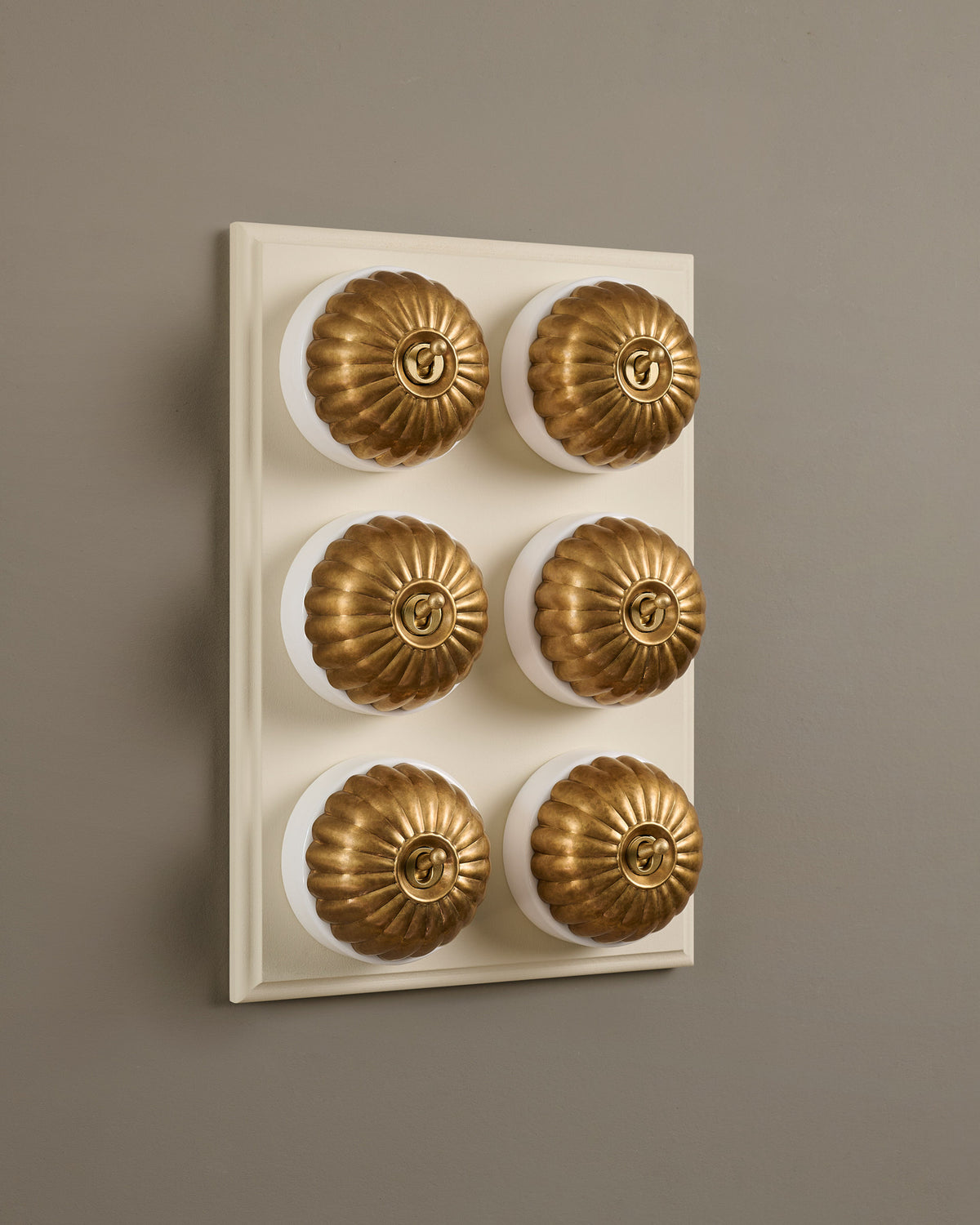 The Jelly Toggle Switch (6 Gang & Primed Maple Pattress) - Aged Brass with White Base. TEST