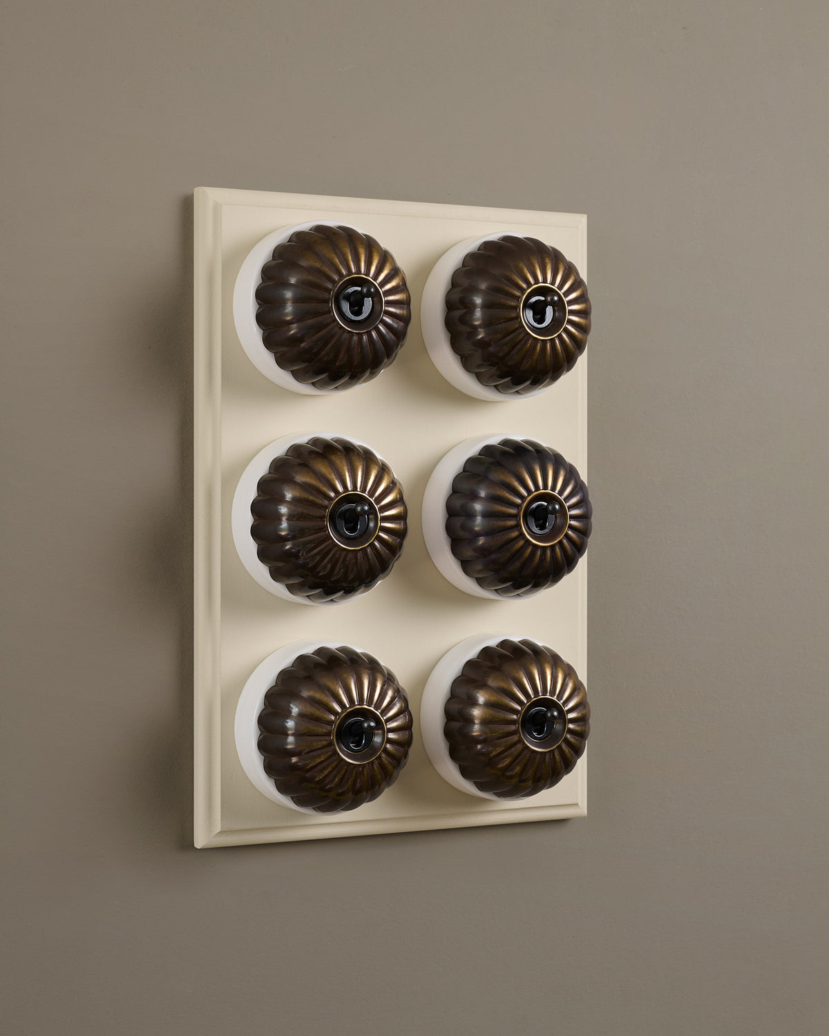 The Jelly Toggle Switch (6 Gang & Primed Maple Pattress) - Oxidised Brass with White Base. TEST