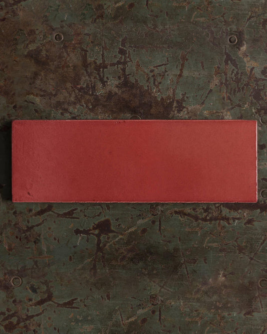 Rectangular red object on a textured green surface | Plain Long Metro