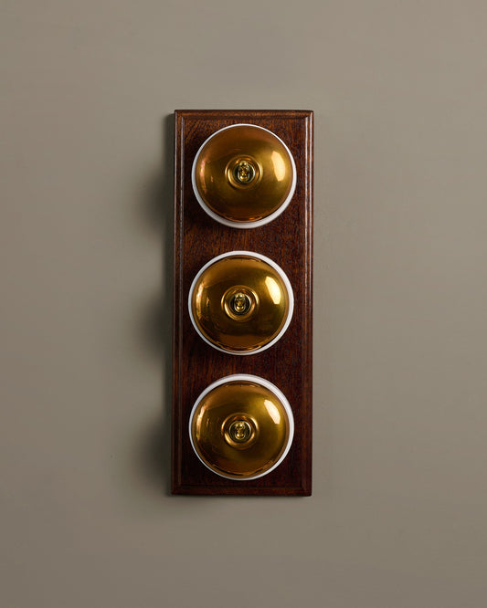 The Dolly Toggle Switch (3 Gang & Mahogany Finish Pattress) - Heirloom Brass with White Base.