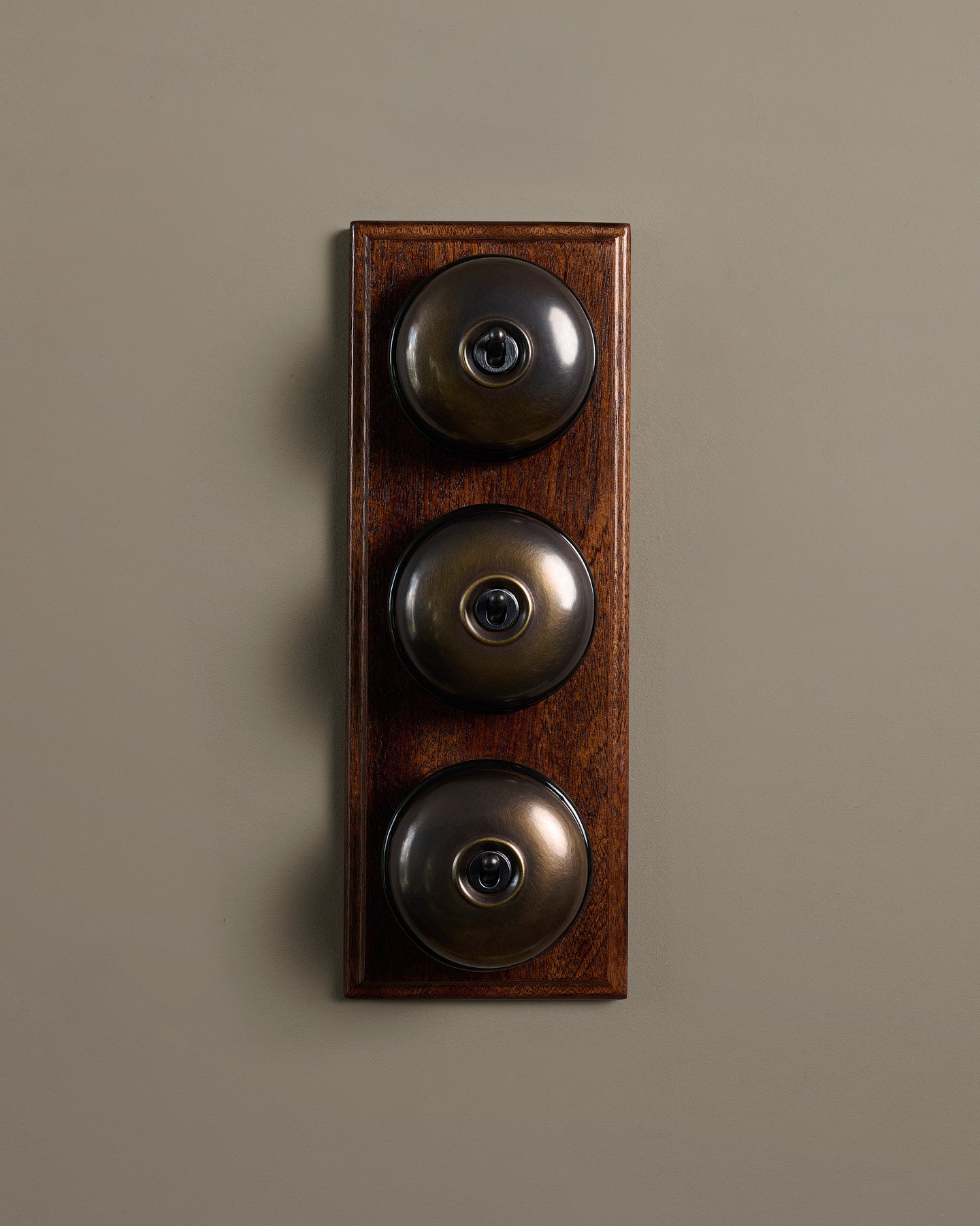 The Dolly Toggle Switch (3 Gang & Mahogany Finish Pattress) - Oxidised Brass with Black Base.