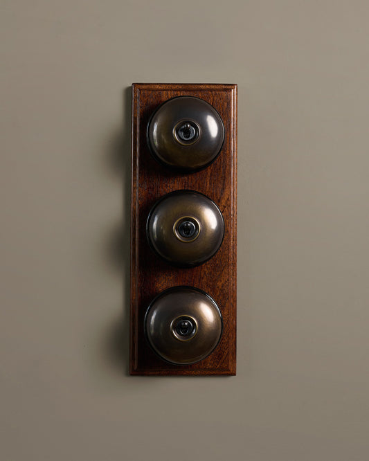 The Dolly Toggle Switch (3 Gang & Mahogany Finish Pattress) - Oxidised Brass with Black Base.