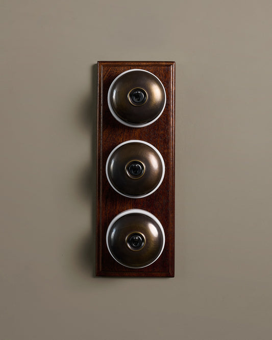 The Dolly Toggle Switch (3 Gang & Mahogany Finish Pattress) - Oxidised Brass with White Base.