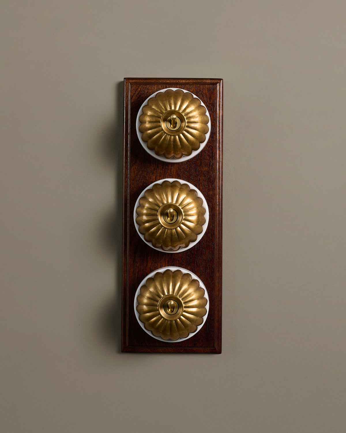 The Jelly Toggle Switch (3 Gang & Mahogany Finish Pattress) - Aged Brass with White Base. TEST