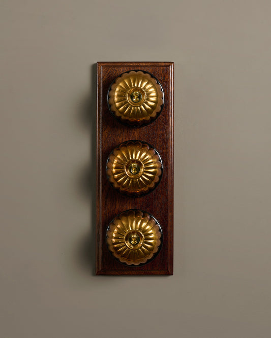 The Jelly Toggle Switch (3 Gang & Mahogany Finish Pattress) - Heirloom Brass with Black Base.
