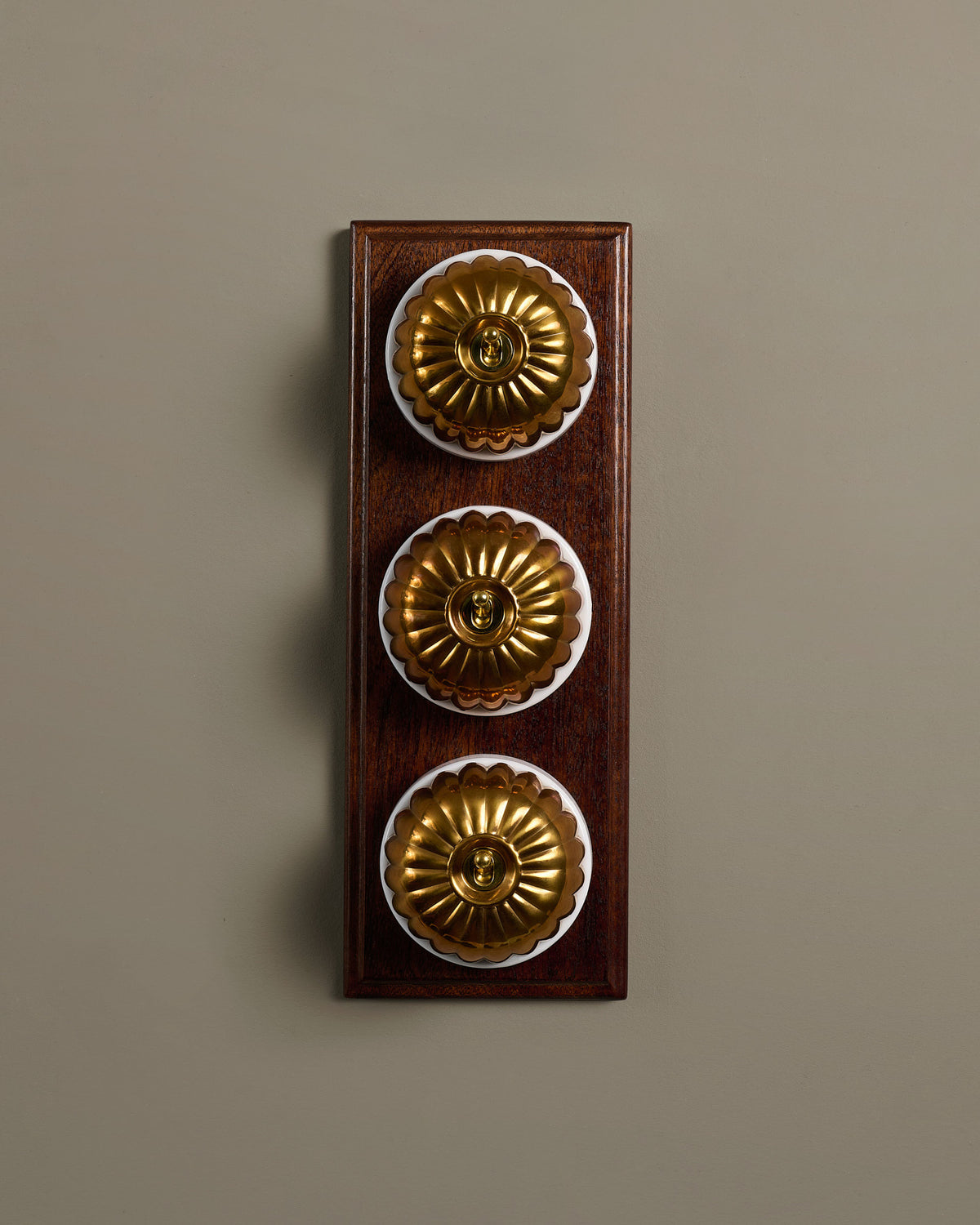 The Jelly Toggle Switch (3 Gang & Mahogany Finish Pattress) - Heirloom Brass with White Base. TEST
