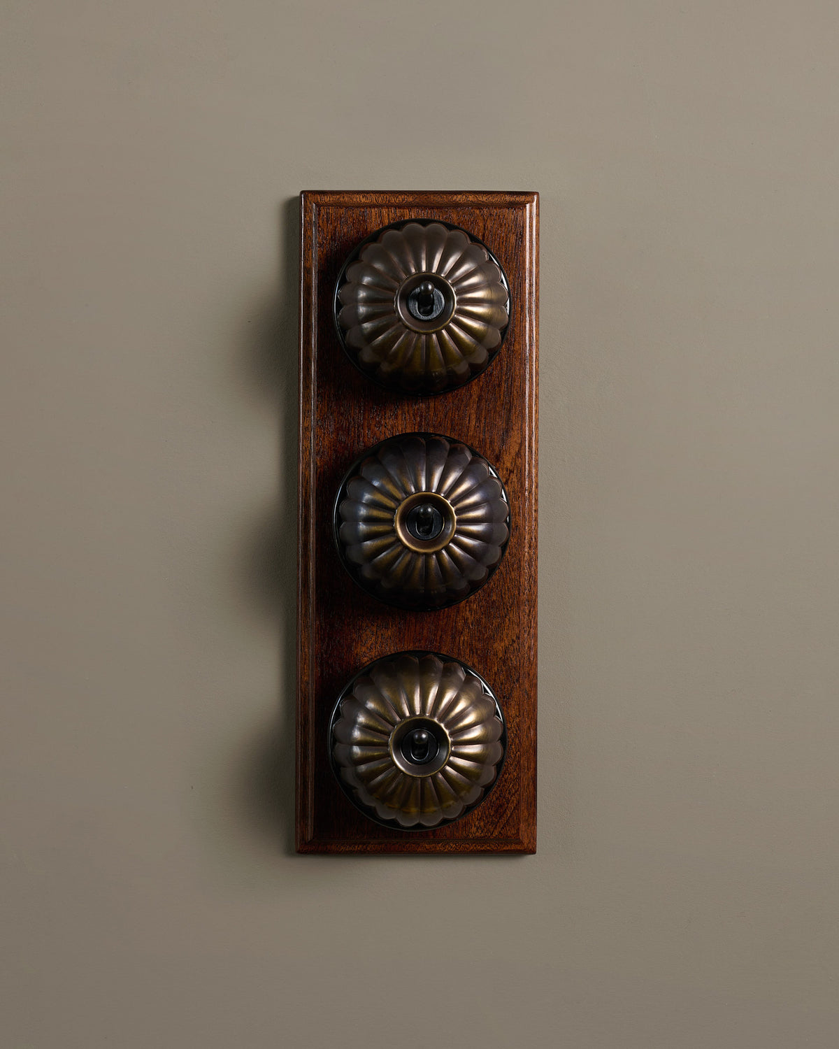 The Jelly Toggle Switch (3 Gang & Mahogany Finish Pattress) - Oxidised Brass with Black Base. TEST