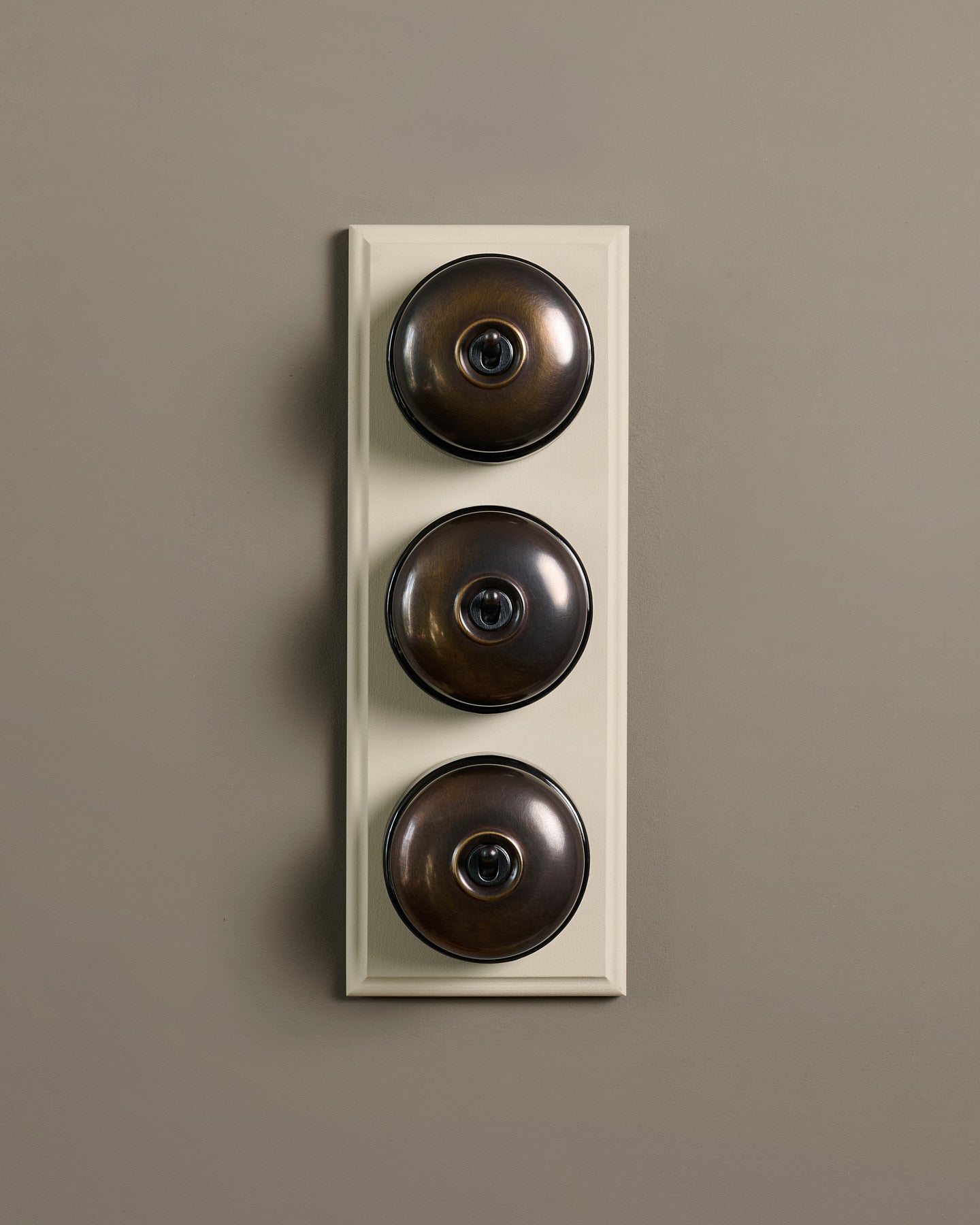 The Dolly Toggle Switch (3 Gang & Primed Maple Pattress) - Oxidised Brass with Black Base.