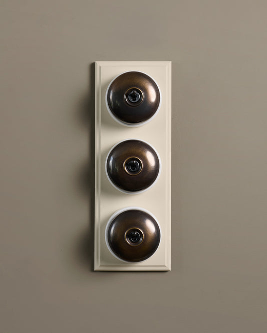 The Dolly Toggle Switch (3 Gang & Primed Maple Pattress) - Oxidised Brass with White Base.