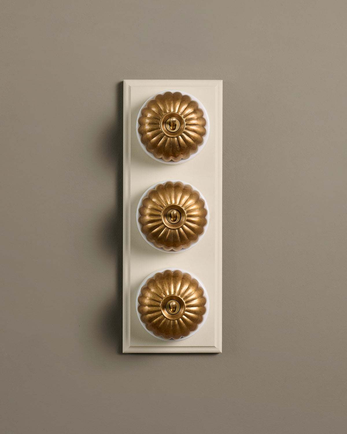 The Jelly Toggle Switch (3 Gang & Primed Maple Pattress) - Aged Brass with White Base. TEST