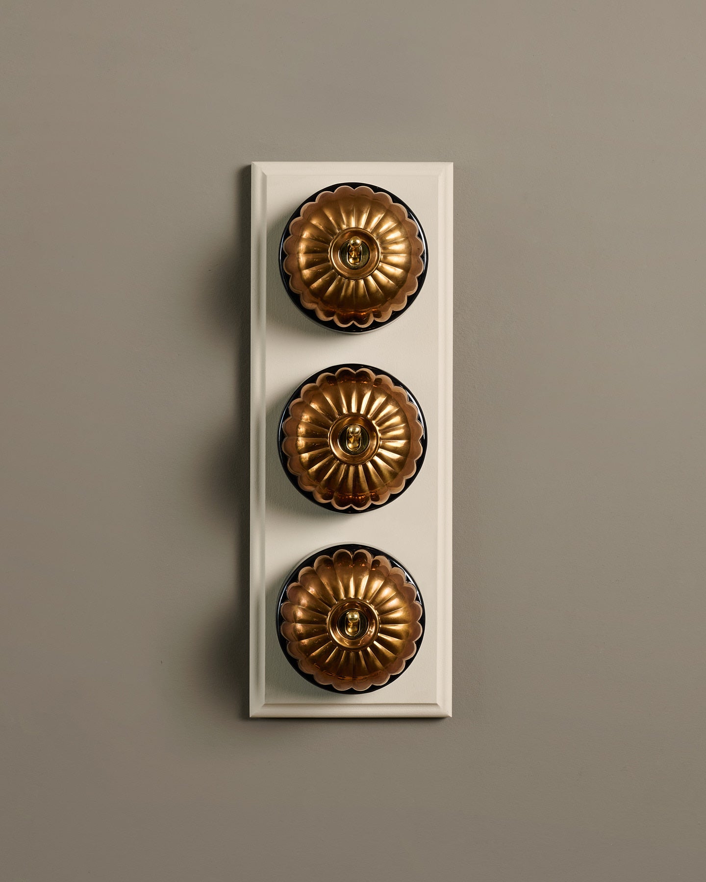 The Jelly Toggle Switch (3 Gang & Primed Maple Pattress) - Heirloom Brass with Black Base.