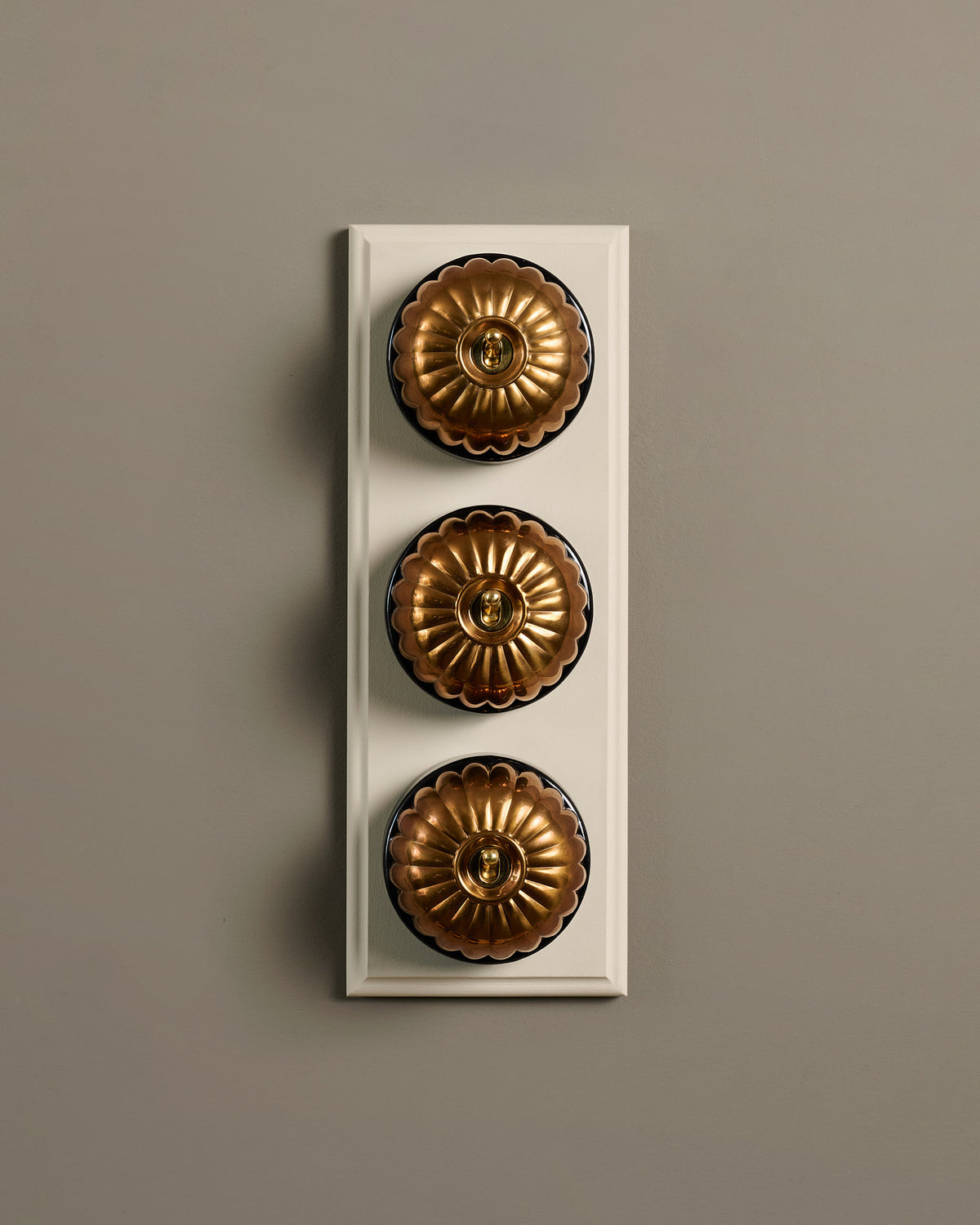 The Jelly Toggle Switch (3 Gang & Primed Maple Pattress) - Heirloom Brass with Black Base. TEST