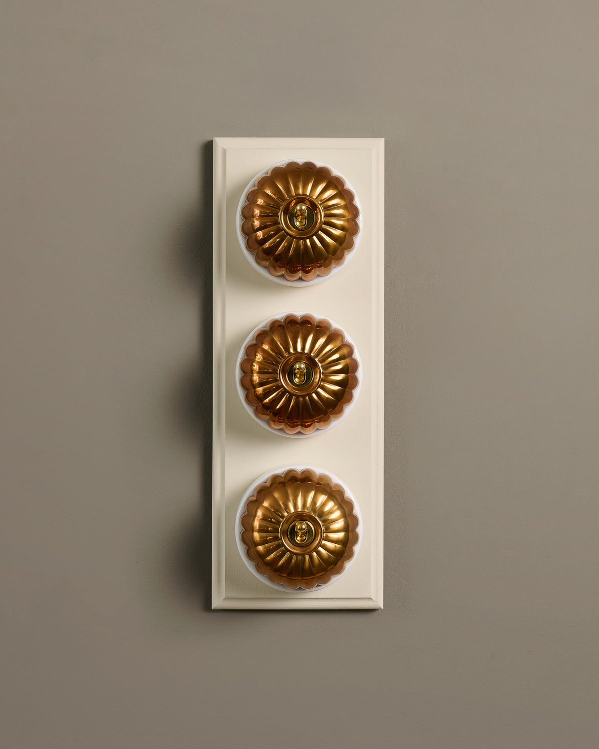 The Jelly Toggle Switch (3 Gang & Primed Maple Pattress) - Heirloom Brass with White Base. TEST