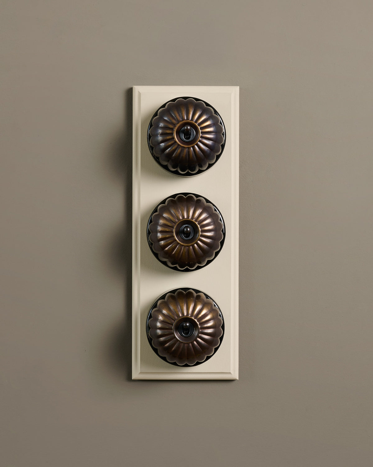 The Jelly Toggle Switch (3 Gang & Primed Maple Pattress) - Oxidised Brass with Black Base. TEST