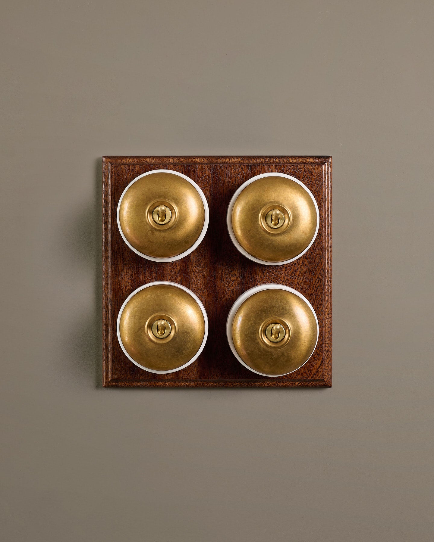 The Dolly Toggle Switch (4 Gang Bank & Mahogany Finish Pattress) - Aged Brass with White Base.
