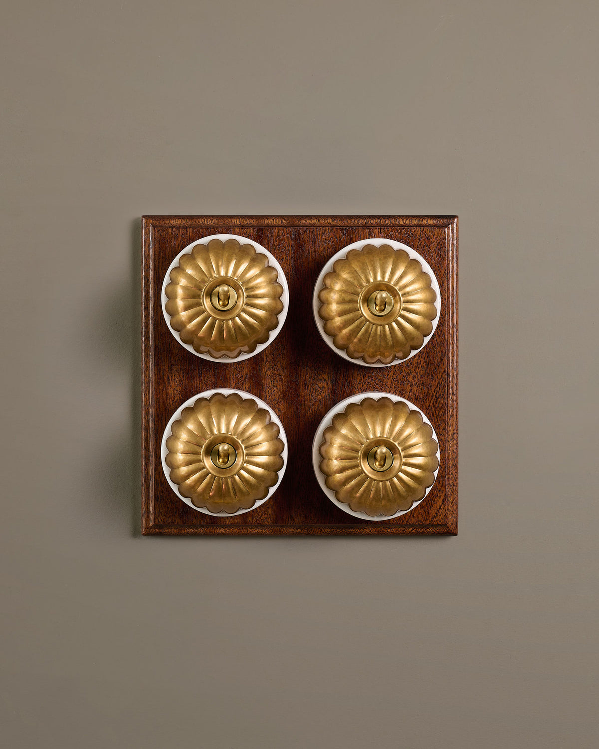 The Jelly Toggle Switch (4 Gang Bank & Mahogany Finish Pattress) - Aged Brass with White Base. TEST
