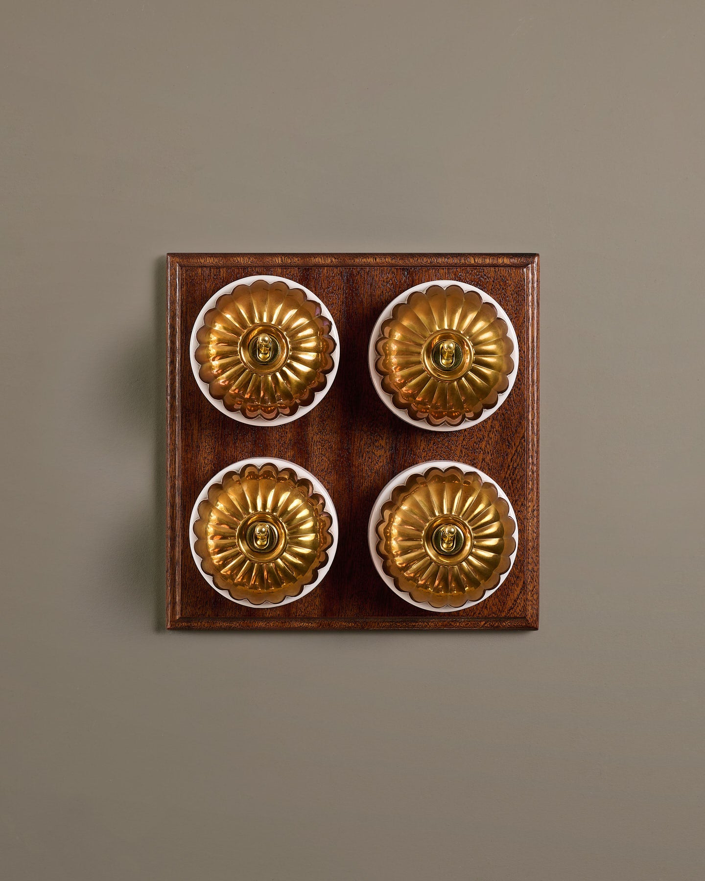 The Jelly Toggle Switch (4 Gang Bank & Mahogany Finish Pattress) - Heirloom Brass with White Base.