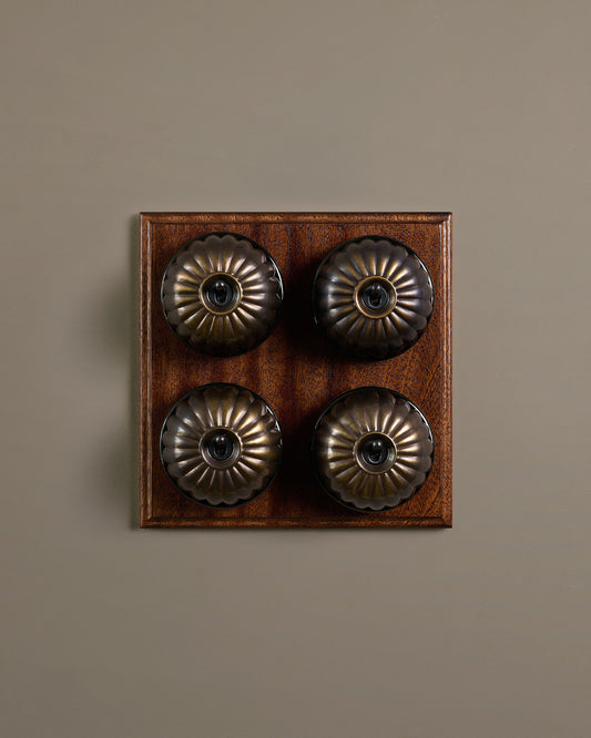 The Jelly Toggle Switch (4 Gang Bank & Mahogany Finish Pattress) - Oxidised Brass with Black Base.