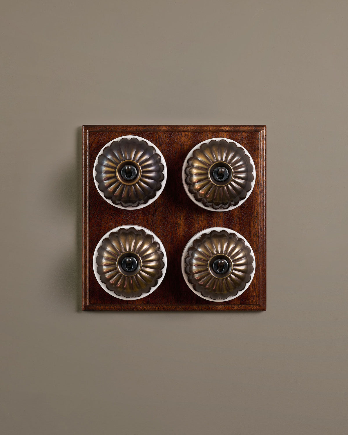 The Jelly Toggle Switch (4 Gang Bank & Mahogany Finish Pattress) - Oxidised Brass with White Base. TEST