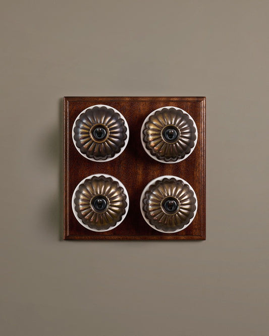 The Jelly Toggle Switch (4 Gang Bank & Mahogany Finish Pattress) - Oxidised Brass with White Base.