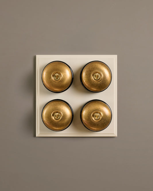 The Dolly Toggle Switch (4 Gang Bank & Primed Maple Pattress) - Aged Brass with Black Base.