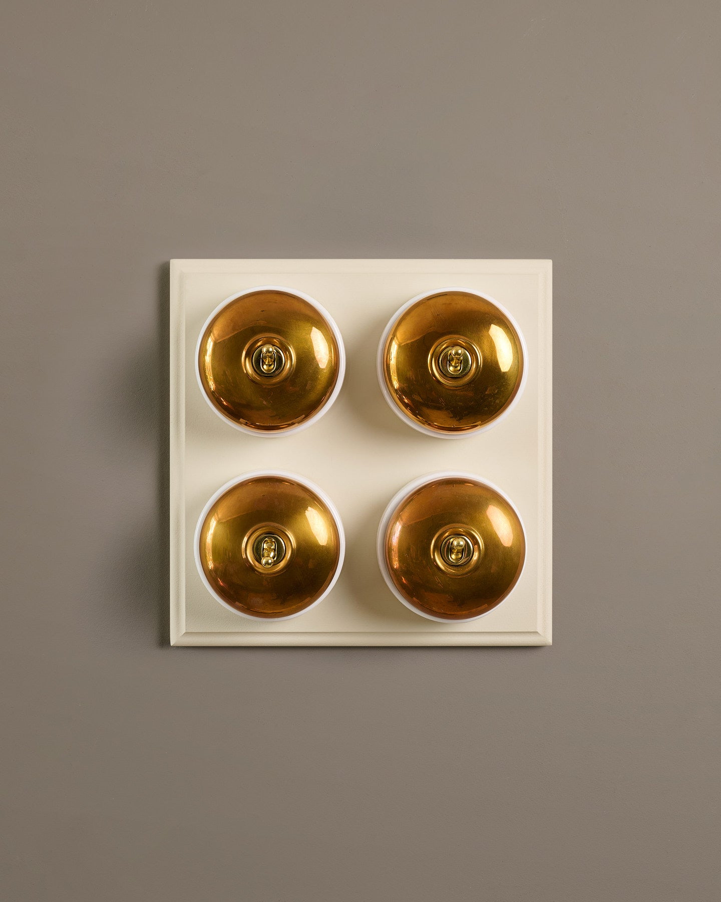 The Dolly Toggle Switch (4 Gang Bank & Primed Maple Pattress) - Heirloom Brass with White Base.