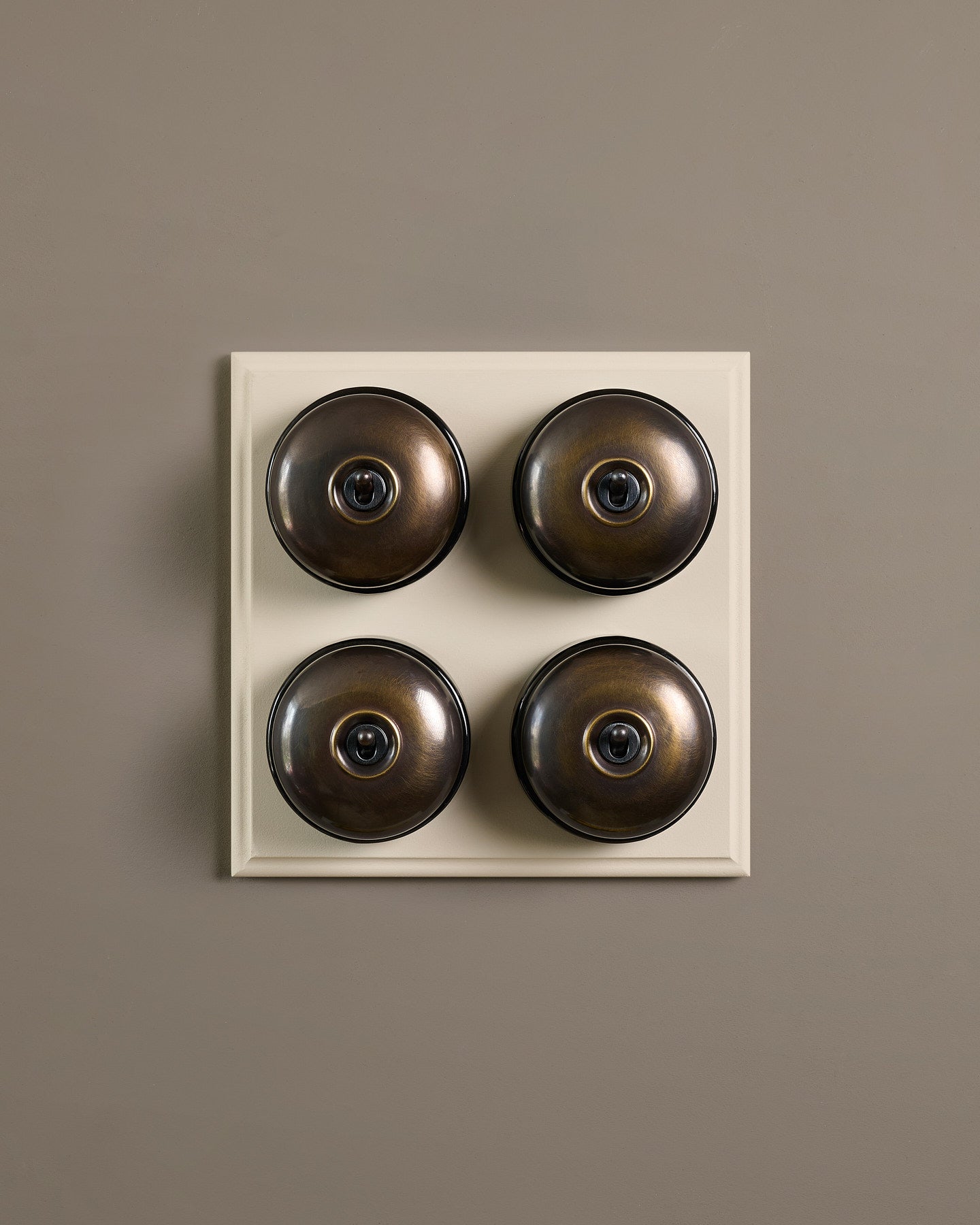 The Dolly Toggle Switch (4 Gang Bank & Primed Maple Pattress) - Oxidised Brass with Black Base.