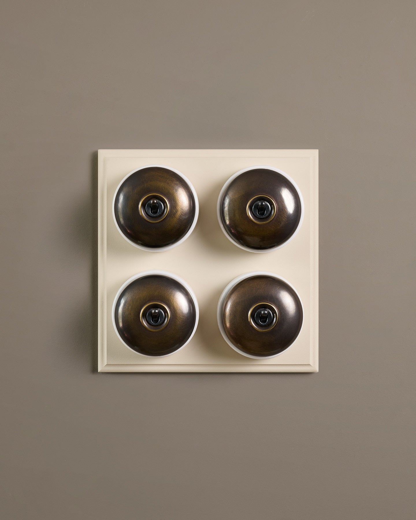 The Dolly Toggle Switch (4 Gang Bank & Primed Maple Pattress) - Oxidised Brass with White Base.