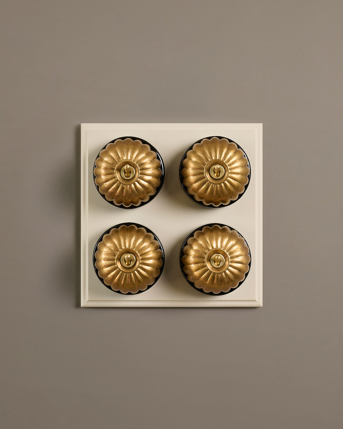 The Jelly Toggle Switch (4 Gang Bank & Primed Maple Pattress) - Aged Brass with Black Base. TEST