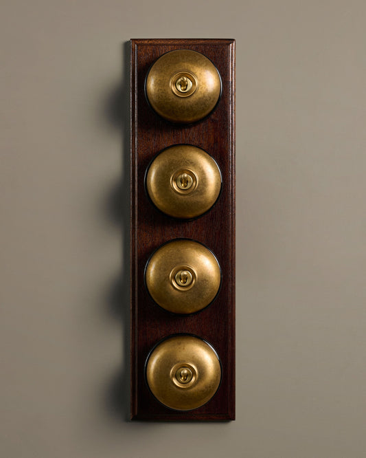 The Dolly Toggle Switch (4 Gang Row & Mahogany Finish Pattress) - Aged Brass with Black Base.