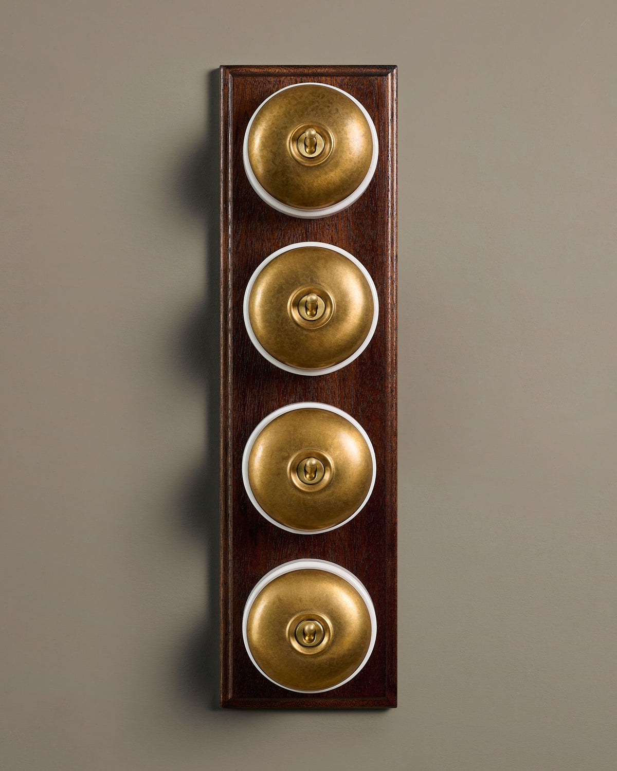 The Dolly Toggle Switch (4 Gang Row & Mahogany Finish Pattress) - Aged Brass with White Base. TEST
