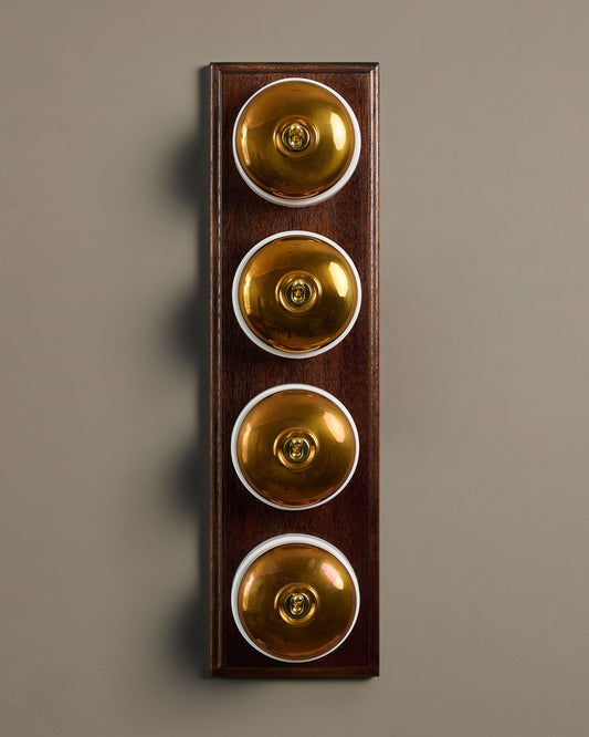 The Dolly Toggle Switch (4 Gang Row & Mahogany Finish Pattress) - Heirloom Brass with White Base.