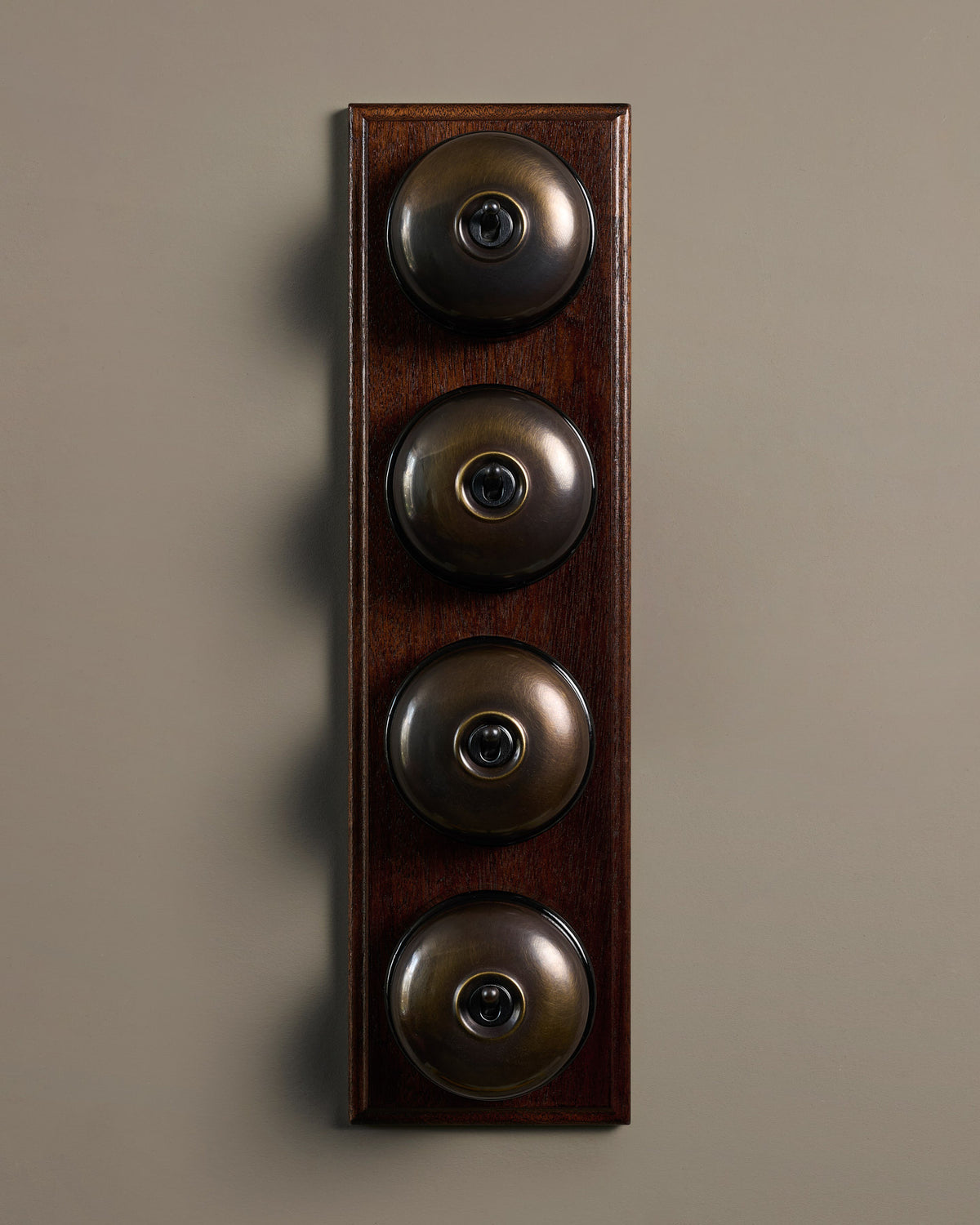 The Dolly Toggle Switch (4 Gang Row & Mahogany Finish Pattress) - Oxidised Brass with Black Base. TEST