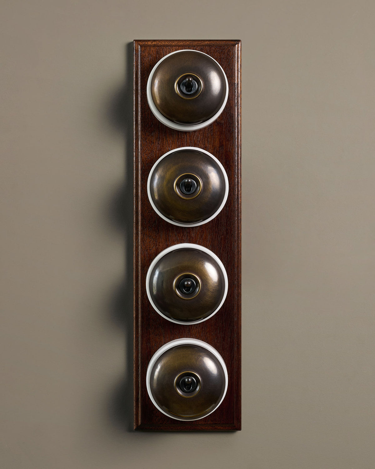 The Dolly Toggle Switch (4 Gang Row & Mahogany Finish Pattress) - Oxidised Brass with White Base. TEST