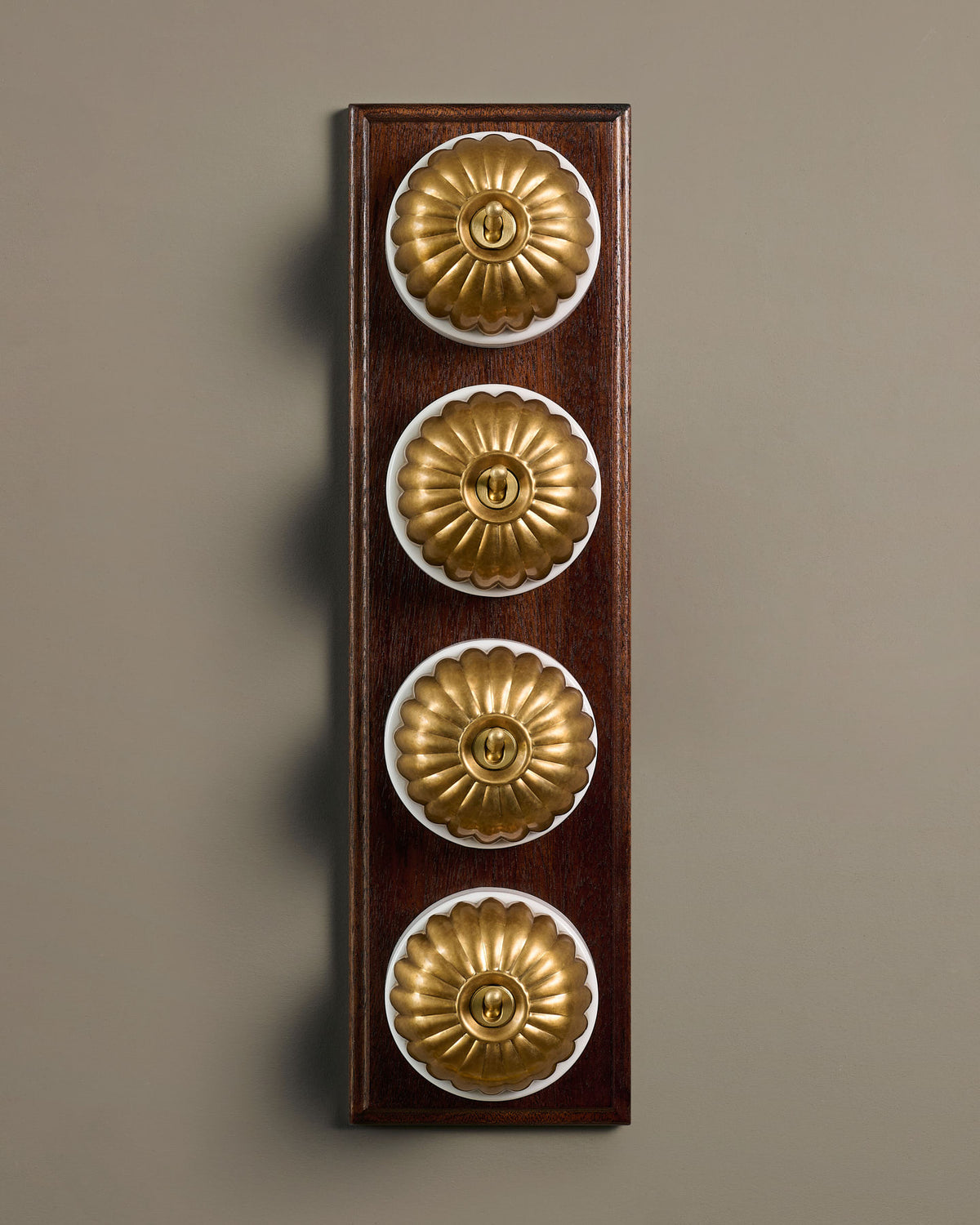 The Jelly Toggle Switch (4 Gang Row & Mahogany Finish Pattress) - Aged Brass with White Base. TEST