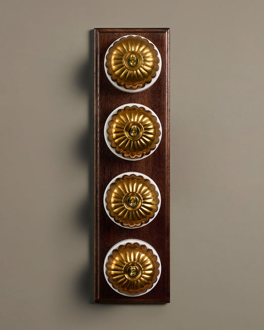 The Jelly Toggle Switch (4 Gang Row & Mahogany Finish Pattress) - Heirloom Brass with White Base.