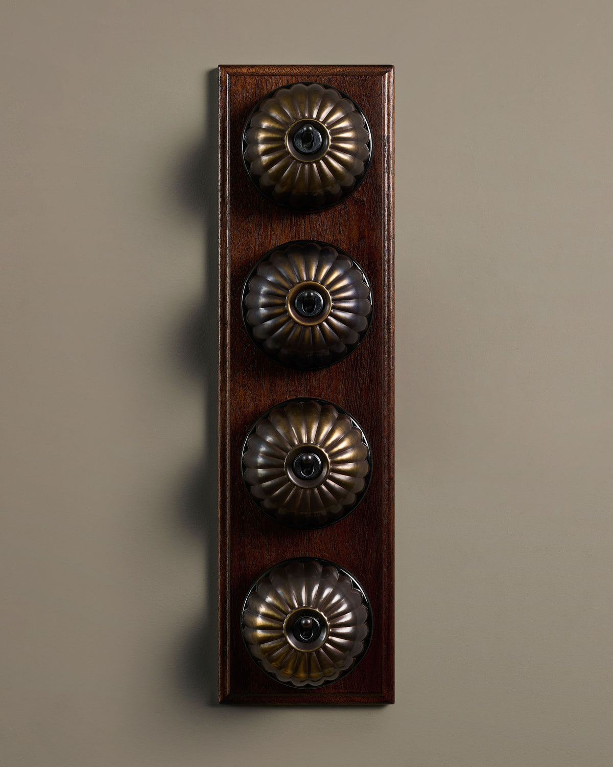 The Jelly Toggle Switch (4 Gang Row & Mahogany Finish Pattress) - Oxidised Brass with Black Base. TEST