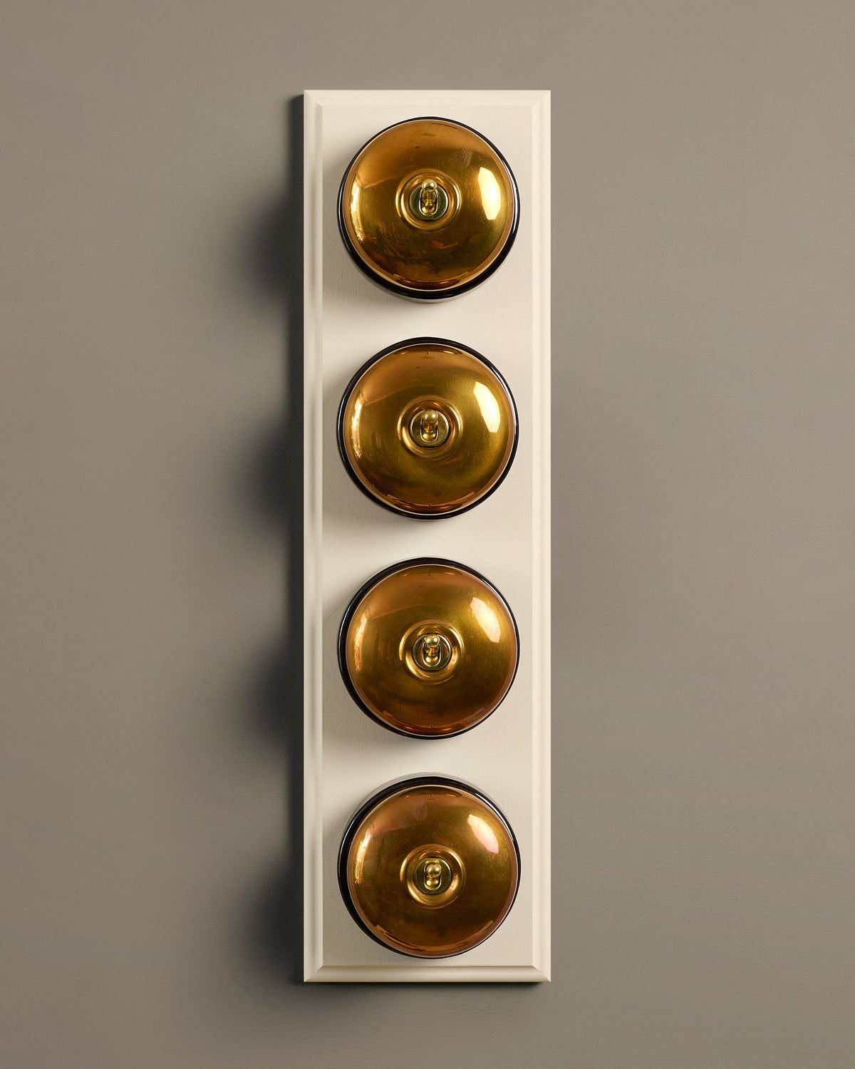 The Dolly Toggle Switch (4 Gang Row & Primed Maple Pattress) - Heirloom Brass with Black Base. TEST