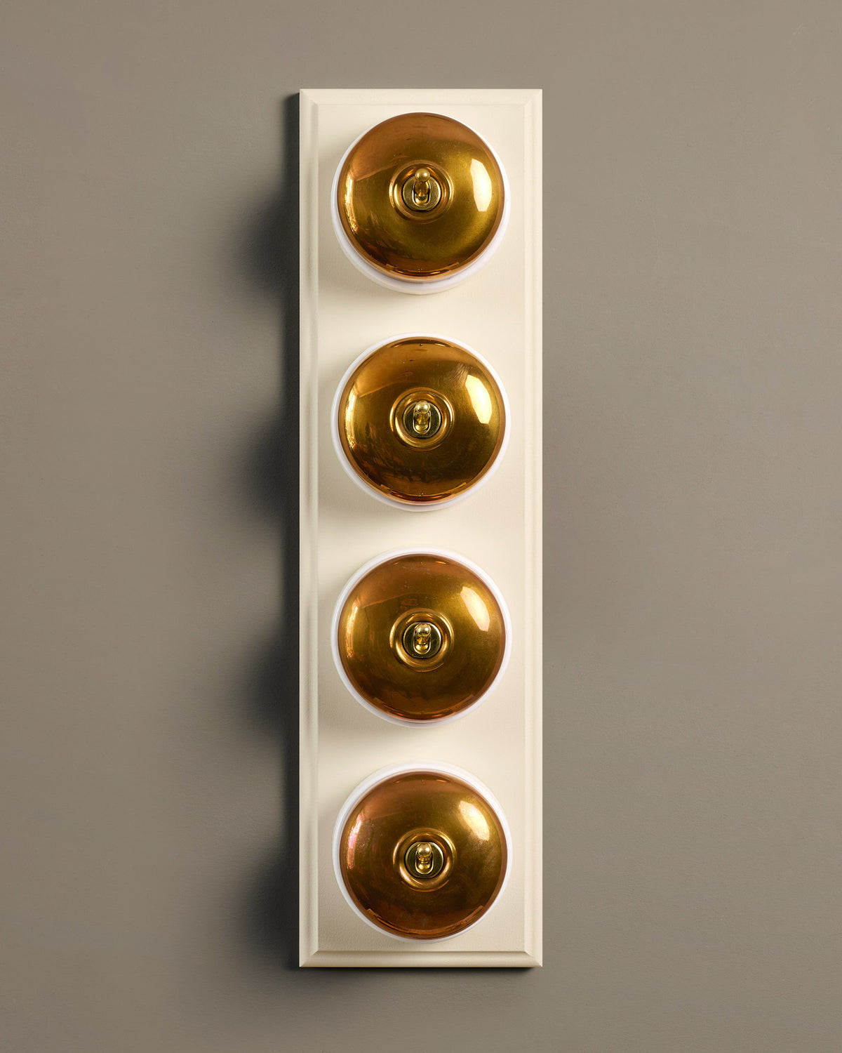 The Dolly Toggle Switch (4 Gang Row & Primed Maple Pattress) - Heirloom Brass with White Base. TEST