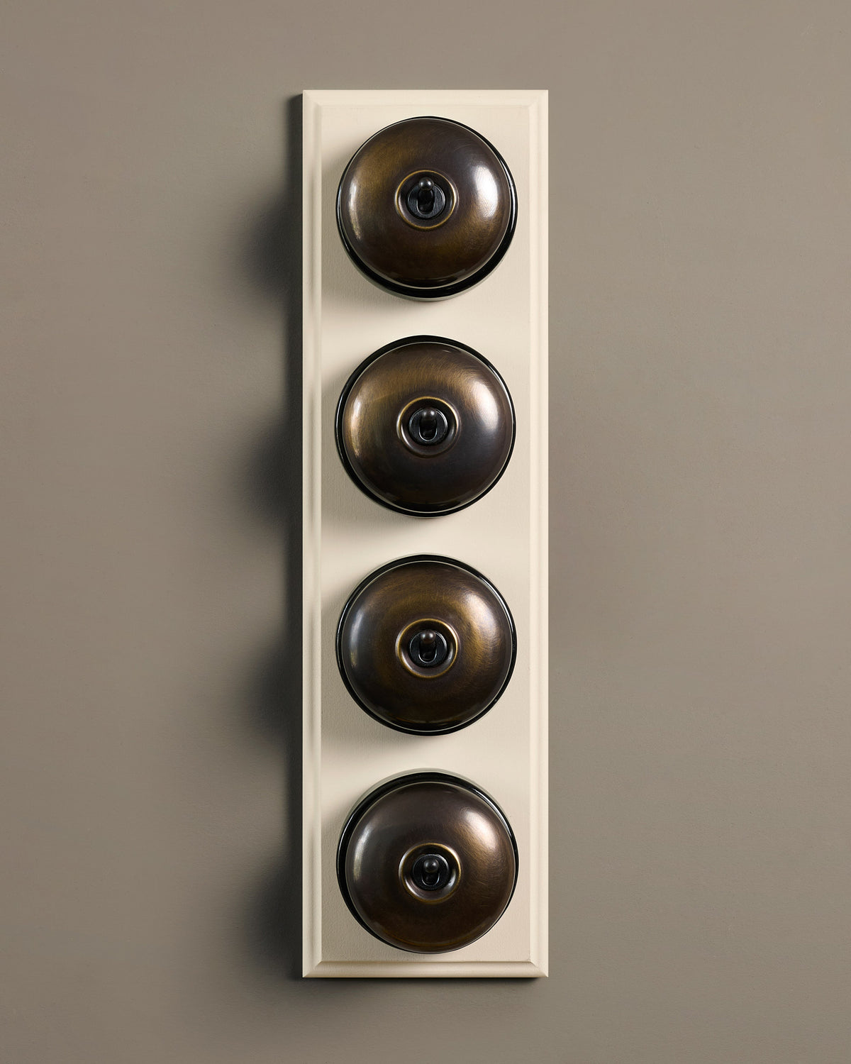 The Dolly Toggle Switch (4 Gang Row & Primed Maple Pattress) - Oxidised Brass with Black Base. TEST