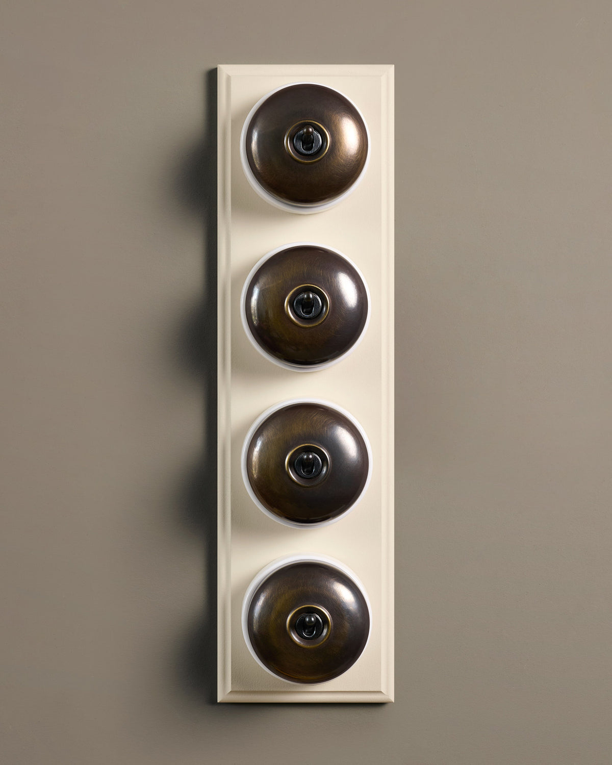 The Dolly Toggle Switch (4 Gang Row & Primed Maple Pattress) - Oxidised Brass with White Base. TEST