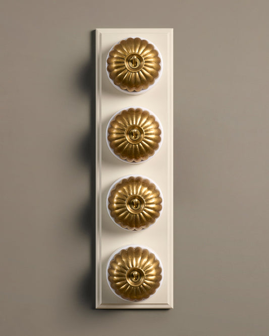 The Jelly Toggle Switch (4 Gang Row & Primed Maple Pattress) - Aged Brass with White Base.