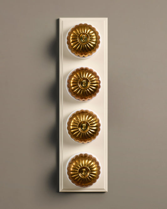 The Jelly Toggle Switch (4 Gang Row & Primed Maple Pattress) - Heirloom Brass with White Base.