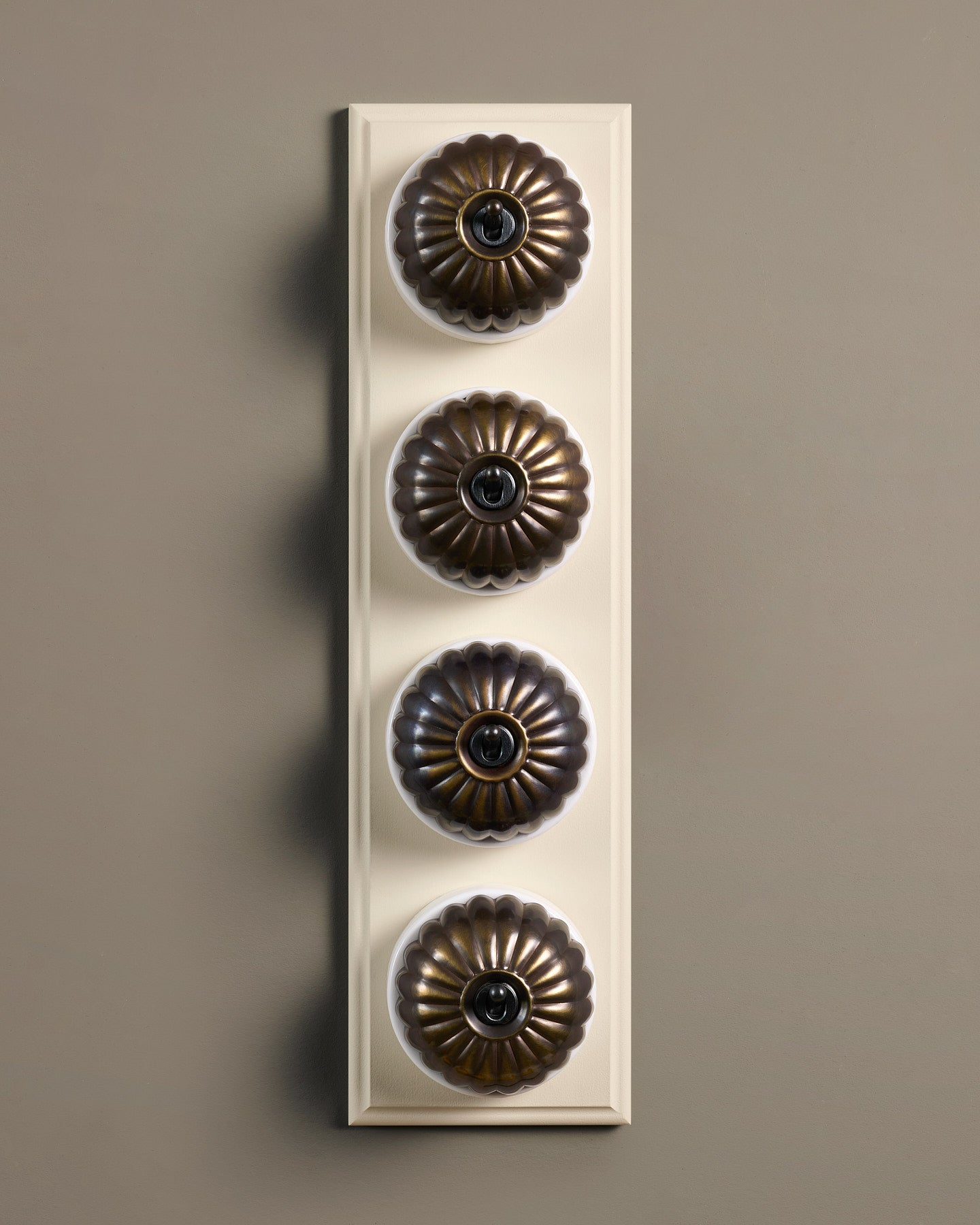 The Jelly Toggle Switch (4 Gang Row & Primed Maple Pattress) - Oxidised Brass with White Base.