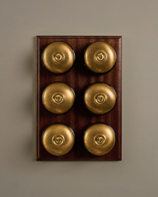 The Dolly Toggle Switch (6 Gang & Mahogany Finish Pattress) - Aged Brass with Black Base.