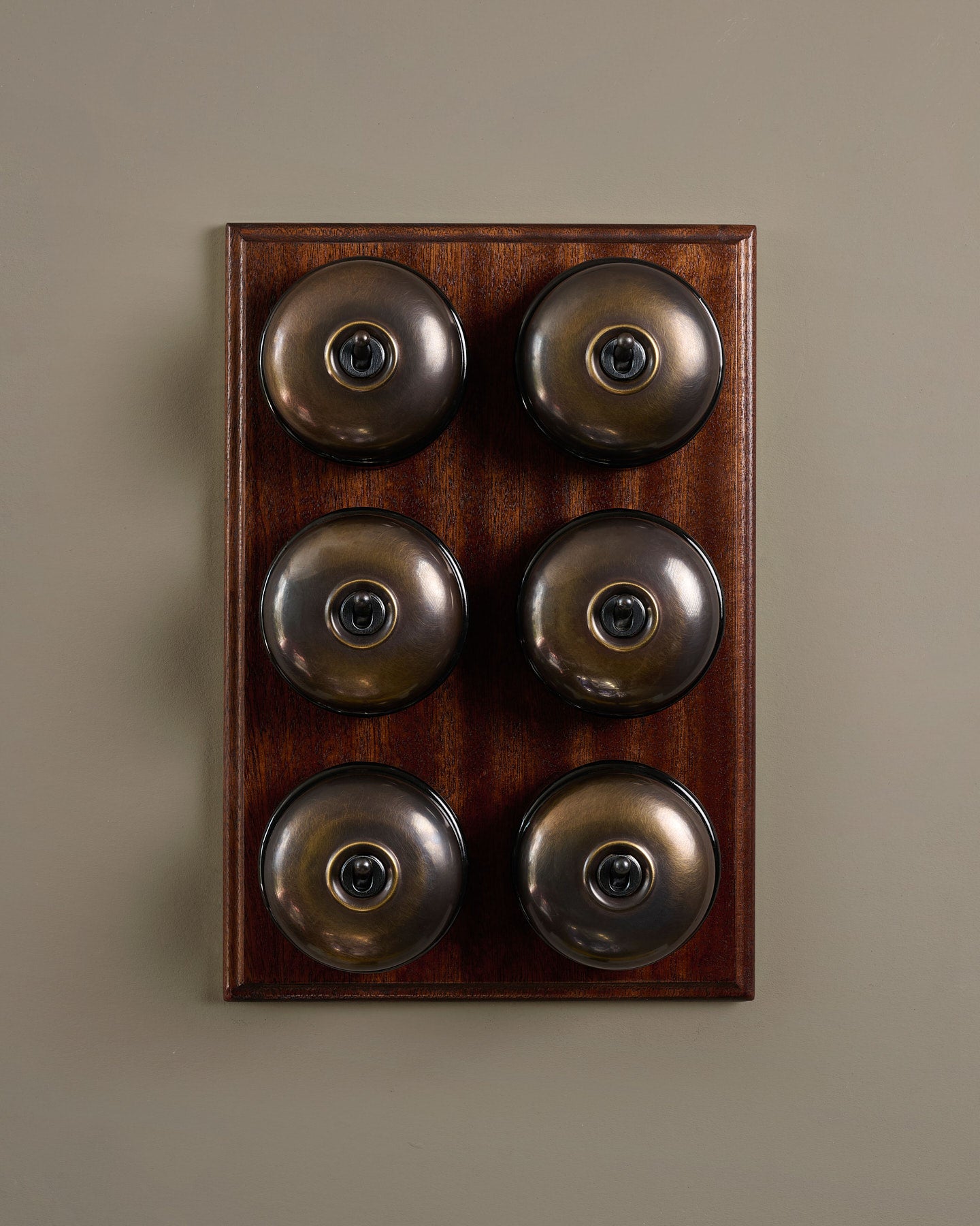 The Dolly Toggle Switch (6 Gang & Mahogany Finish Pattress) - Oxidised Brass with Black Base.