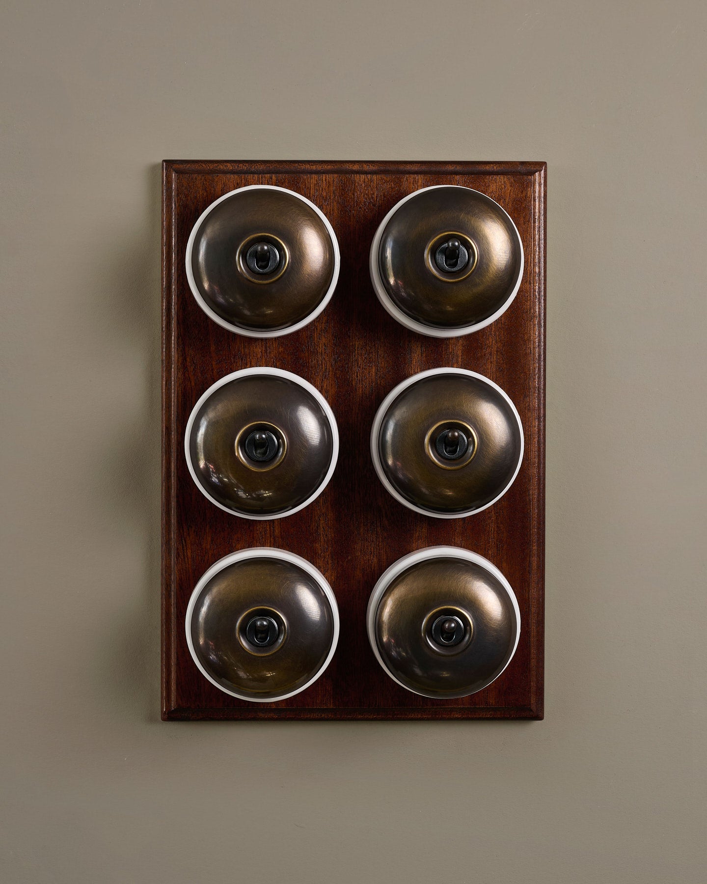 The Dolly Toggle Switch (6 Gang & Mahogany Finish Pattress) - Oxidised Brass with White Base.