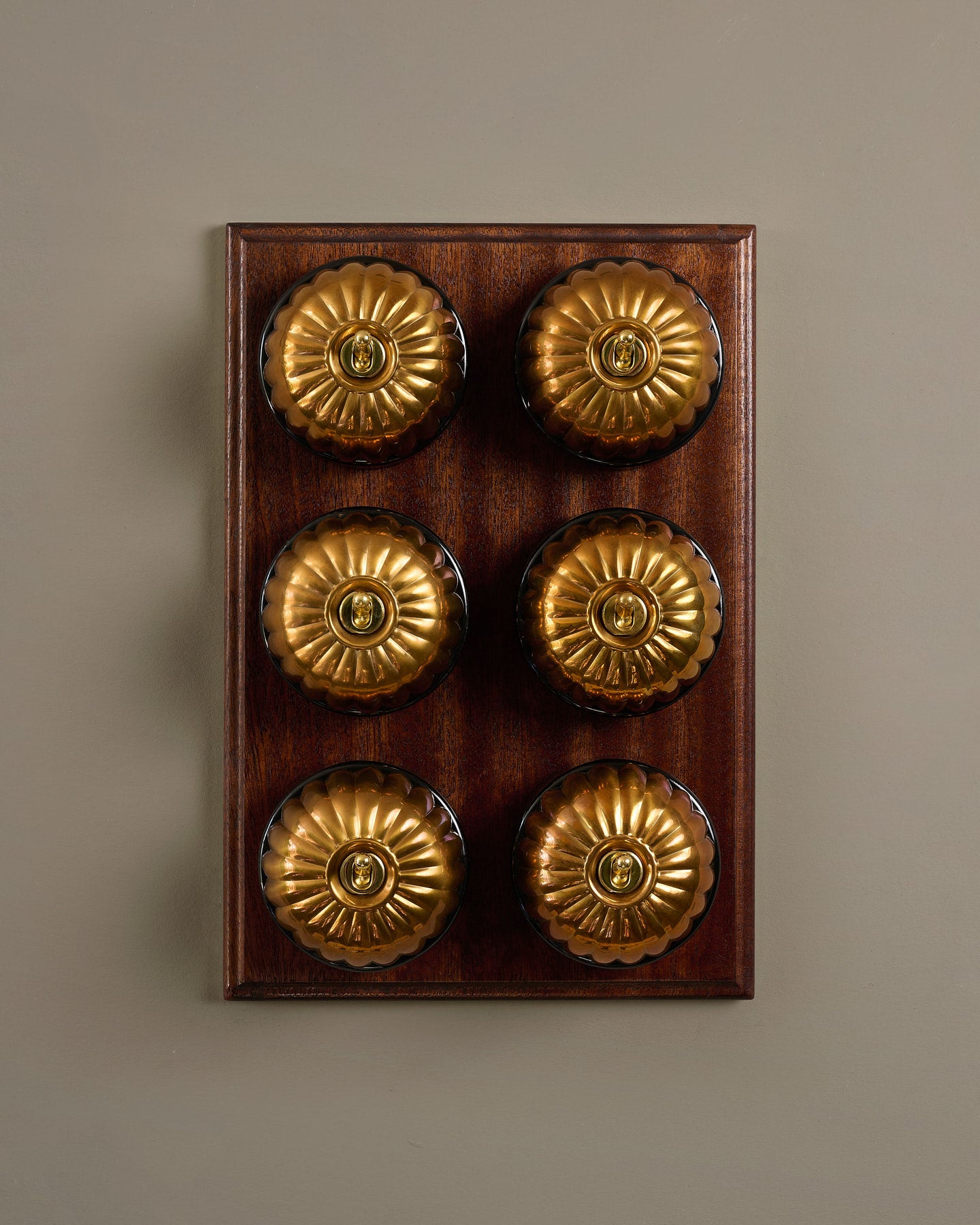The Jelly Toggle Switch (6 Gang & Mahogany Finish Pattress) - Heirloom Brass with Black Base.