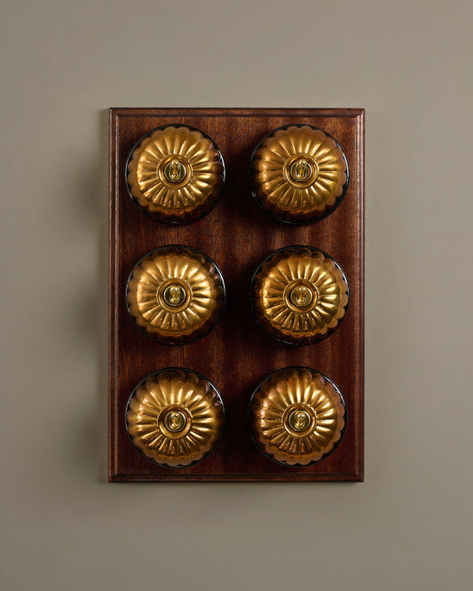 The Jelly Toggle Switch (6 Gang & Mahogany Finish Pattress) - Heirloom Brass with Black Base.
